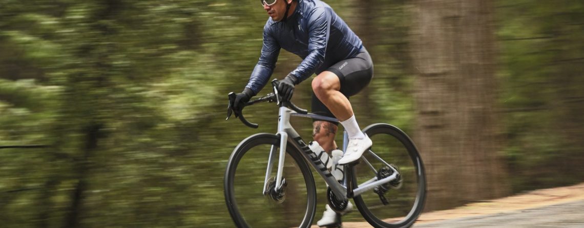 Road cyclist riding a Giant Defy on a forest road